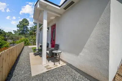 a patio with chairs and a table and a red door at Modern Oasis New 2BR in La Mesa in La Mesa