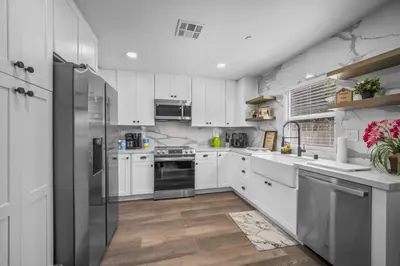 a kitchen with white cabinets and stainless steel appliances at Modern Oasis New 2BR in La Mesa in La Mesa