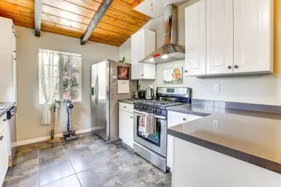 a kitchen with a stove and a refrigerator at Peaceful Vista House with Gas Grill 1 Mi to Dtwn! in Vista