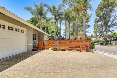 a house with a wooden fence and a driveway at Peaceful Vista House with Gas Grill 1 Mi to Dtwn! in Vista