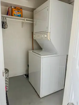 a kitchen with a white refrigerator and a white cabinet at Beautiful Loft in Little Italy SD with Parking in San Diego