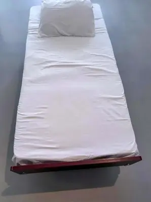 a bed with white sheets on top of it at Beautiful Loft in Little Italy SD with Parking in San Diego