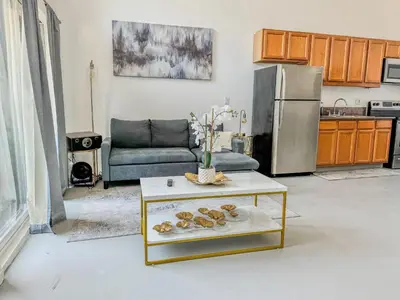 a living room with a couch and a table at Beautiful Loft in Little Italy SD with Parking in San Diego