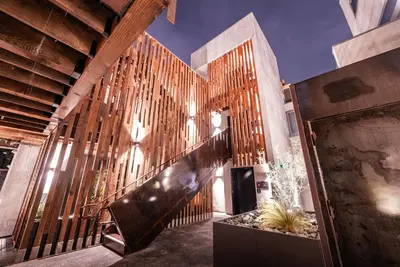 a lobby with a wooden wall and a staircase at City24 Condo Hotel Little Italy Mission Hills in San Diego