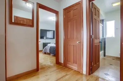 a hallway with a door leading to a bedroom at 100 Yards Ocean & Surfing Ocean Views Backyard in San Diego