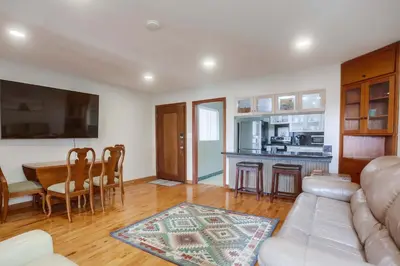 a living room with a couch and a table at 100 Yards Ocean & Surfing Ocean Views Backyard in San Diego