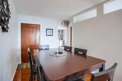 a dining room with a wooden table and chairs at Steps 2 Ocean & Surfing Ocean Views Rooftop Deck in San Diego