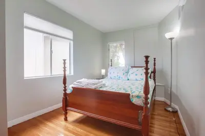 a bedroom with a bed and a window at Steps 2 Ocean & Surfing Ocean Views Rooftop Deck in San Diego