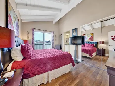 a bedroom with a large bed and a television at 3607 Seashore A & B in Newport Beach