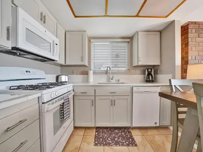 a kitchen with white cabinets and a stove top oven at 3607 Seashore A & B in Newport Beach