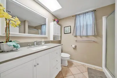 a bathroom with a sink and a toilet and a mirror at 3607 Seashore A & B in Newport Beach