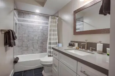 a bathroom with a sink and a toilet and a shower at Ocean-view home blocks to beach with private hot tub & rooftop deck in San Diego