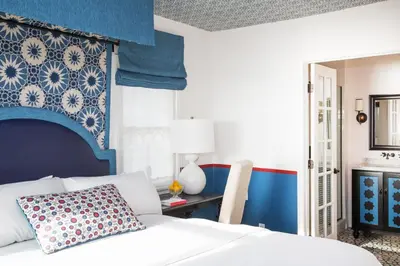 a bedroom with a white bed and a blue wall at Casa Laguna Hotel & Spa in Laguna Beach