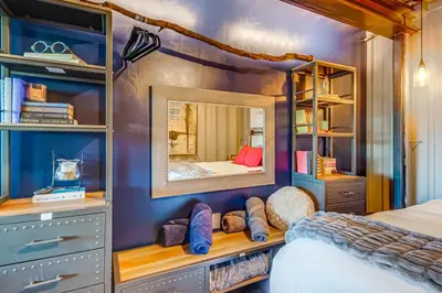 a bedroom with a bed and a mirror at Fallbrook Airplane Home with Fire Pit and Mtn Views! in Temecula