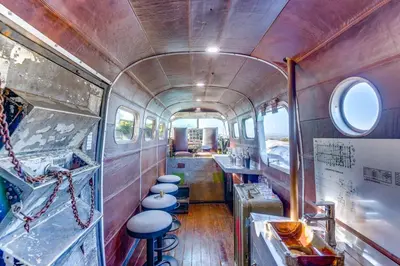an inside view of an old train car with stools at Fallbrook Airplane Home with Fire Pit and Mtn Views! in Temecula