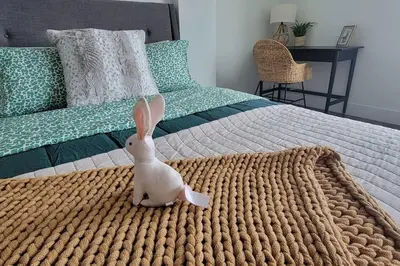 a stuffed rabbit sitting on top of a bed at Bayviews Lux One-bedroom Apartment 1min to Petco Park Convention Center Gaslamp Pool, Hot Tub in San Diego