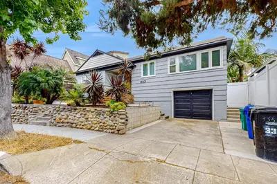 a house with a garage and a fence at Playa Del Sur Getaway La Jolla in San Diego