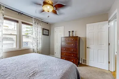 a bedroom with a bed and a ceiling fan at Playa Del Sur Getaway La Jolla in San Diego