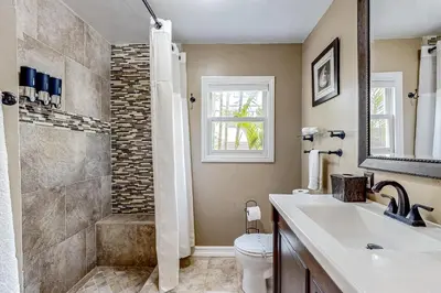 a bathroom with a shower and a toilet and a sink at Playa Del Sur Getaway La Jolla in San Diego