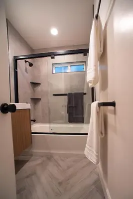 a bathroom with a shower and a bath tub at Modern Ocean Beach Apartment in San Diego