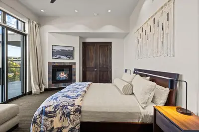 a bedroom with a bed and a fireplace at Dana Point Luxe in Dana Point