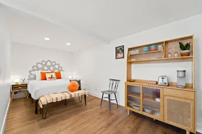 a bedroom with a bed and a wooden floor at Polk Casita by Rather Be Properties in San Diego
