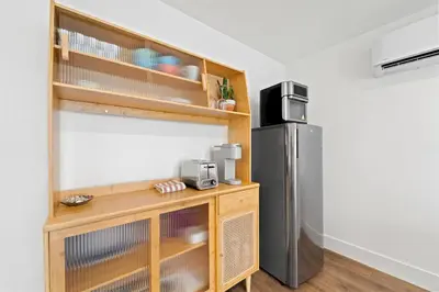 a kitchen with a refrigerator and a wooden table at Polk Casita by Rather Be Properties in San Diego