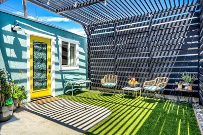 a patio with chairs and a yellow door at Polk Casita by Rather Be Properties in San Diego