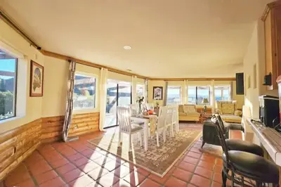 a living room with a table and chairs at Panorama Paradiso by CasadeLuz, 5Acre 360 Retreat close to Old Town Temecula Wine Country in Temecula