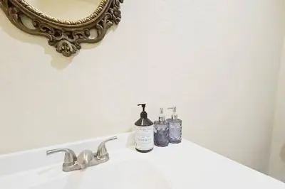 a bathroom sink with two bottles of soap and a mirror at Panorama Paradiso by CasadeLuz, 5Acre 360 Retreat close to Old Town Temecula Wine Country in Temecula