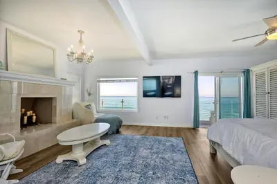 a bedroom with a bed and a fireplace at Oceanfront Getaway, Private Beach, Fire Pit, 5BR in Oceanside
