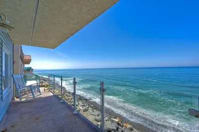 a view of the ocean from the balcony of a house at Oceanfront Getaway, Private Beach, Fire Pit, 5BR in Oceanside
