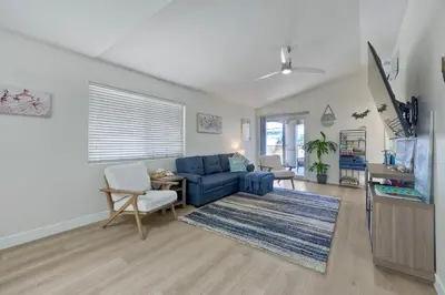 a living room with a blue couch and a table at 1128 Tait Street, Unit D in Oceanside