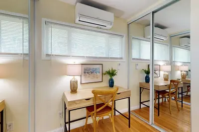 a dining room with a table and chairs and windows at Blue Oasis Cozy Home in San Diego