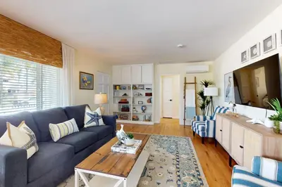a living room with a blue couch and a table at Blue Oasis Cozy Home in San Diego