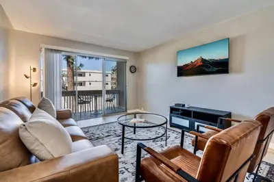 a living room with a couch and a table at Pacific Beach Resort Condo - Walk to the Beach in San Diego