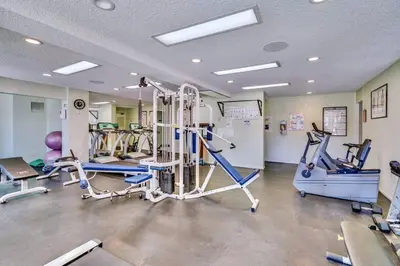 a gym with treadmills and machines in a room at Pacific Beach Resort Condo - Walk to the Beach in San Diego