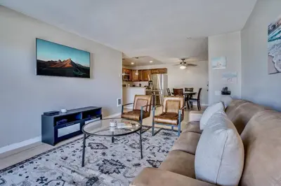 a living room with a couch and a table at Pacific Beach Resort Condo - Walk to the Beach in San Diego