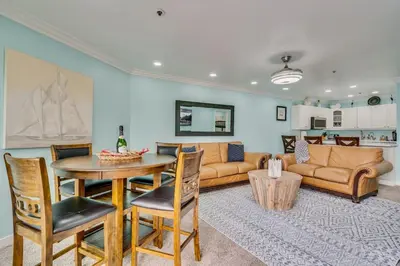 a living room with a table and a couch at Beach Front Bliss - Entire Condo - Crystal Pier in San Diego