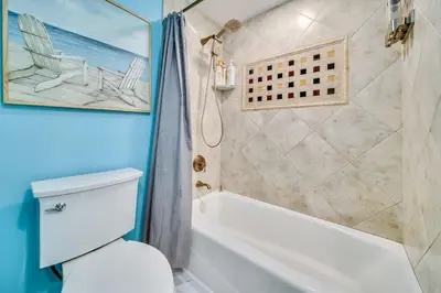 a bathroom with a tub and a toilet and a shower at Beach Front Bliss - Entire Condo - Crystal Pier in San Diego