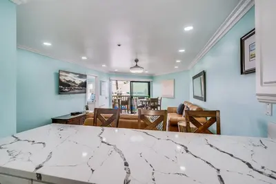 a dining room and living room with a table at Beach Front Bliss - Entire Condo - Crystal Pier in San Diego