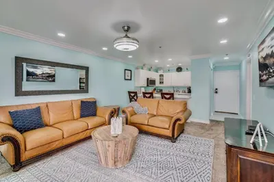 a living room with a couch and a table at Beach Front Bliss - Entire Condo - Crystal Pier in San Diego