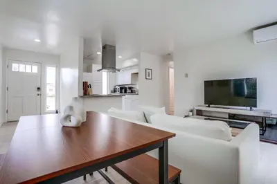 a living room with white furniture and a table at A-C 3 Blocks to Ocean Downtown La Jolla Remodel in San Diego