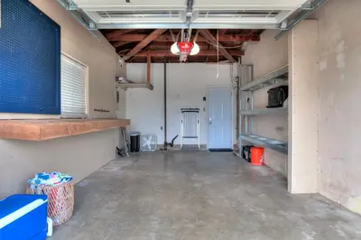 an empty garage with a large room with a tv at Beachside Bliss Spacious 3BR Retreat, Steps to Ocean in Oceanside