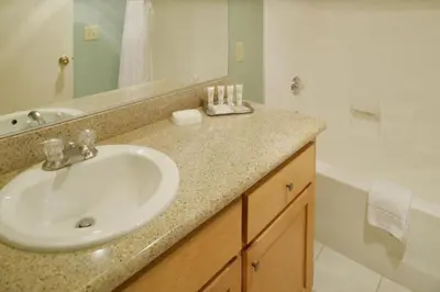 a bathroom counter with a sink and a tub at Diamond Riviera Oaks Resort and Racquet Club 2BD in Ramona