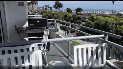 a balcony with a laptop computer sitting on a table at Diamond - Riviera Beach and Spa Resort 2bd in Dana Point