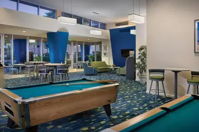 a pool table in a room with tables and chairs at WorldMark Oceanside 2BD in Oceanside