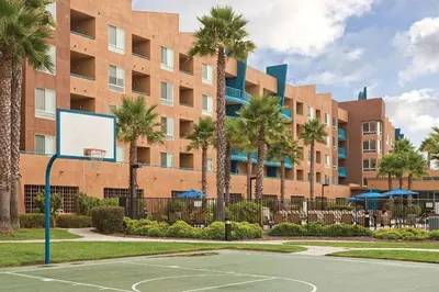 a basketball court in front of a building with palm trees at WorldMark Oceanside 2BD in Oceanside