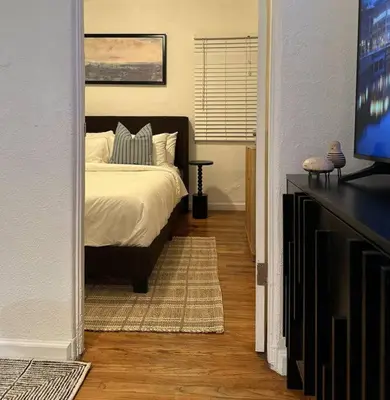 a bedroom with a bed and a flat screen tv at Modern Eclectic 1BR by Downtown, Airport & More in San Diego