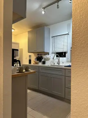 a kitchen with white cabinets and a sink at Modern Eclectic 1BR by Downtown, Airport & More in San Diego